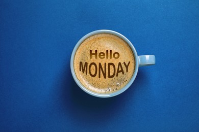 Image of Hello Monday, start your week with good mood. Cup of freshly brewed aromatic coffee on blue background, top view