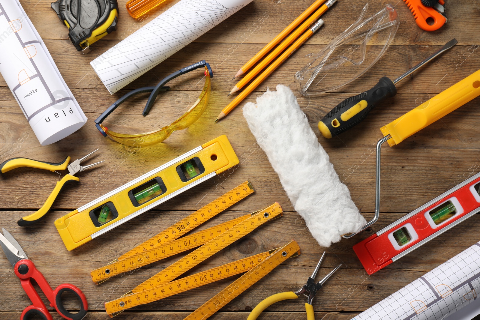 Photo of Flat lay composition with building level and other construction tools on wooden table