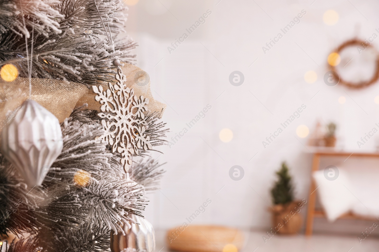 Photo of Closeup view of decorated Christmas tree in room, space for text. Festive interior