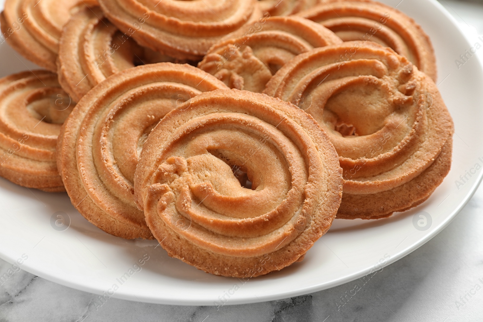 Photo of Plate with Danish butter cookies on table, closeup