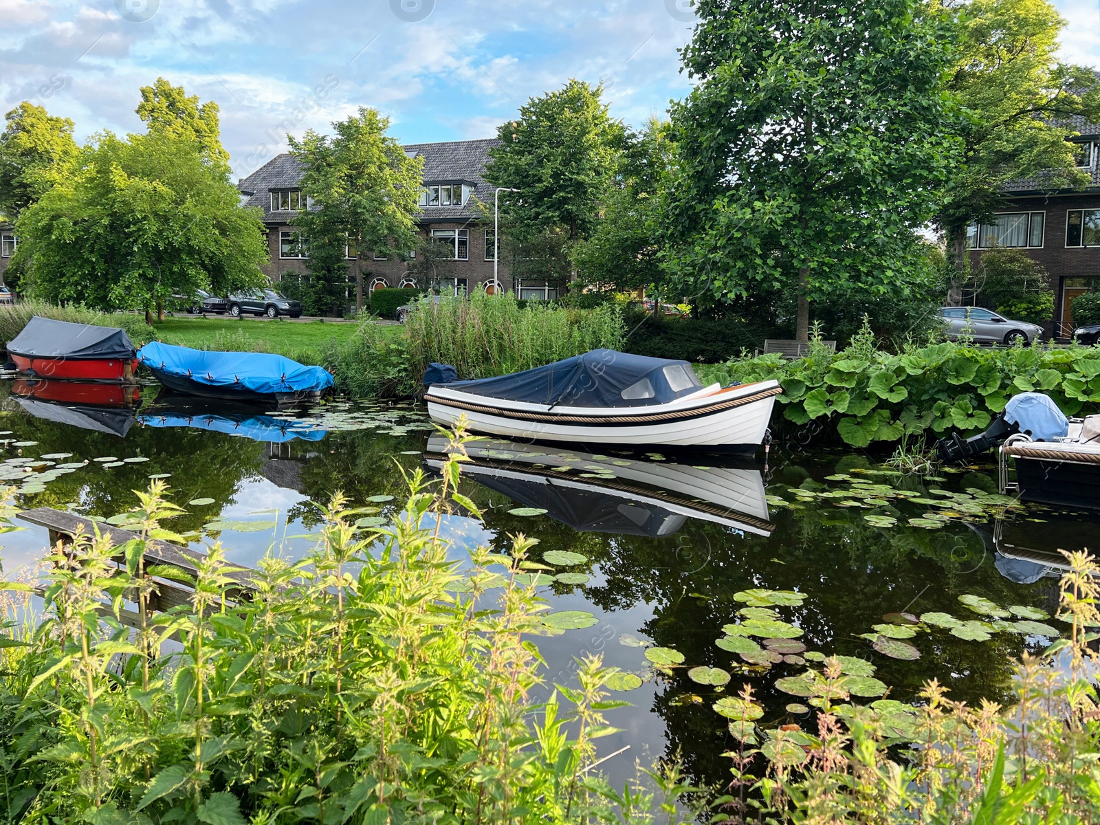 Photo of Beautiful view of moored boats in canal on sunny day