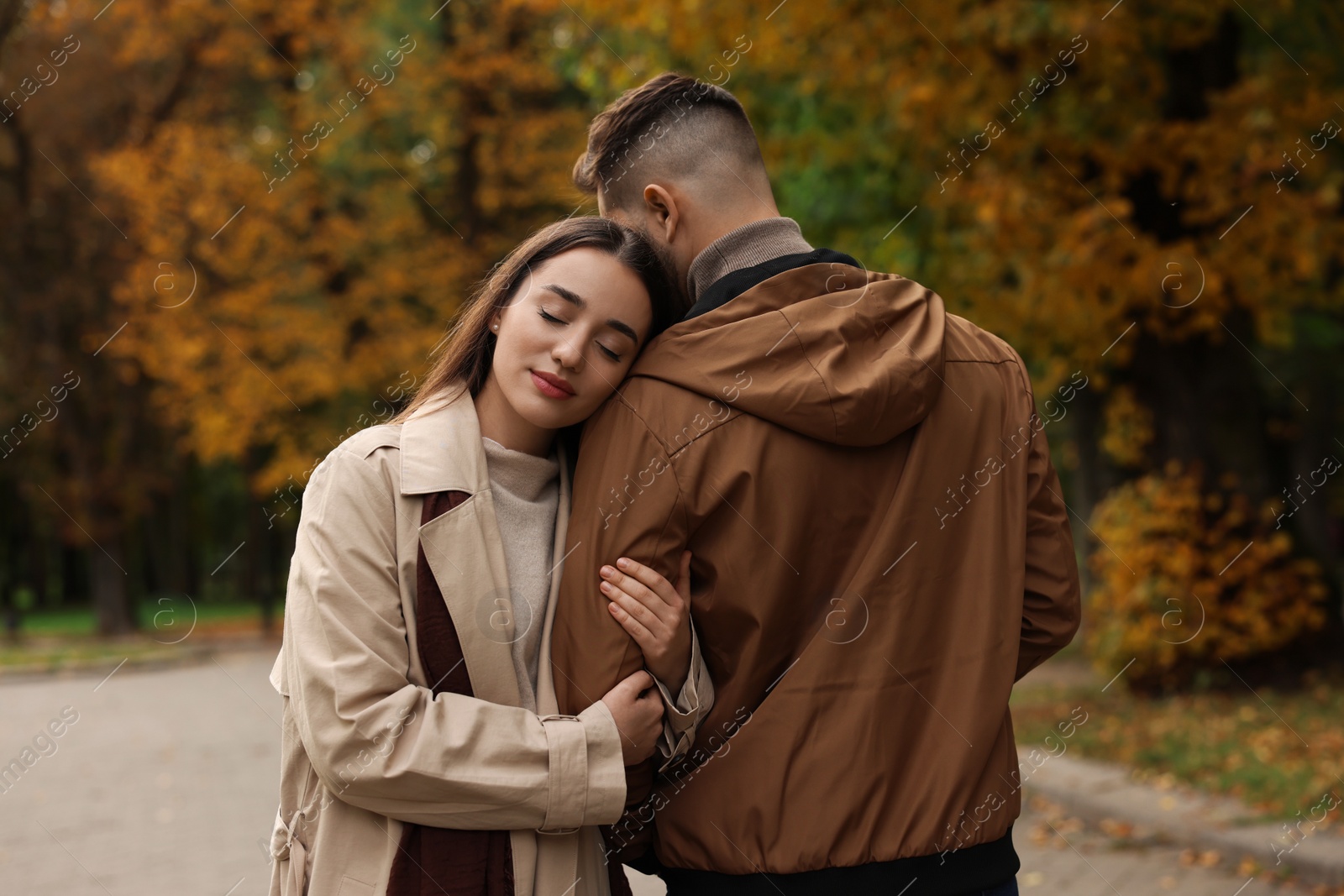 Photo of Happy young couple spending time together in autumn park