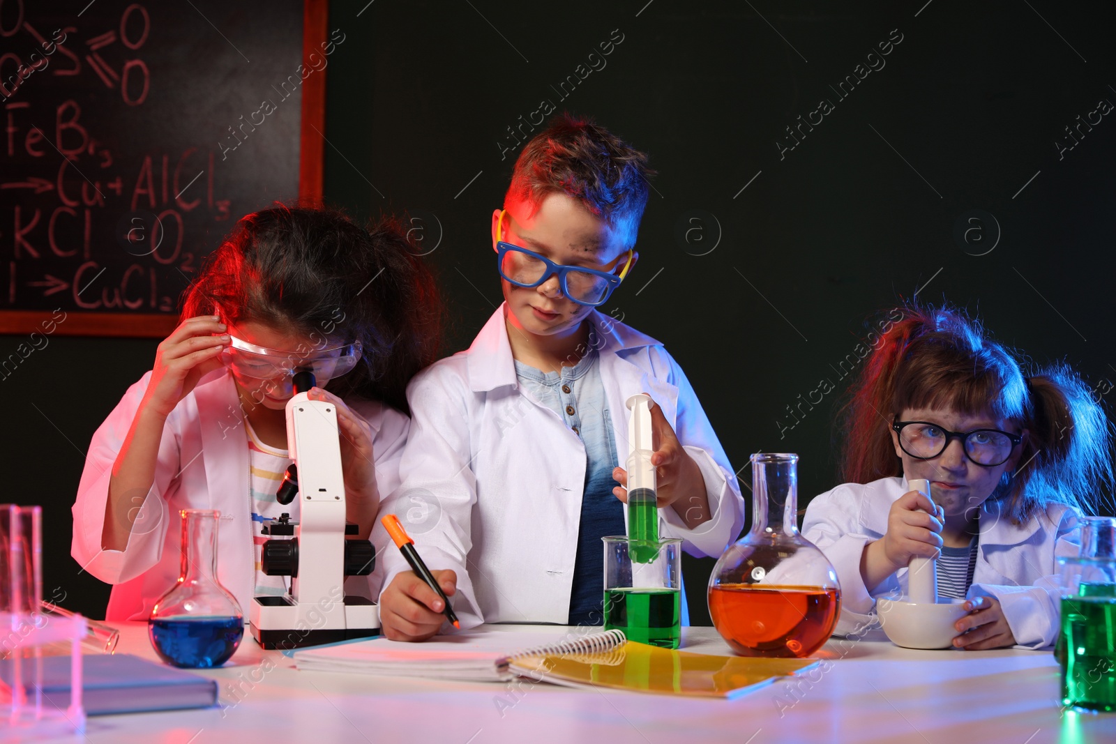 Photo of Children doing chemical research in laboratory. Dangerous experiment