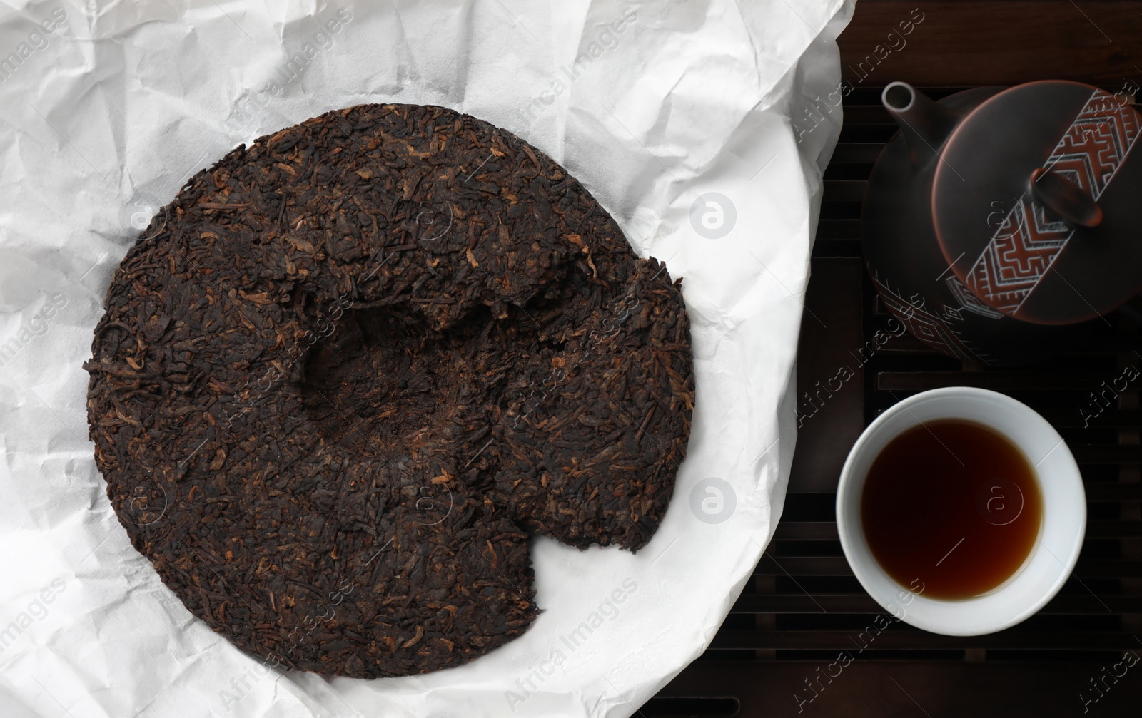 Photo of Flat lay composition with pu-erh tea on wooden tray