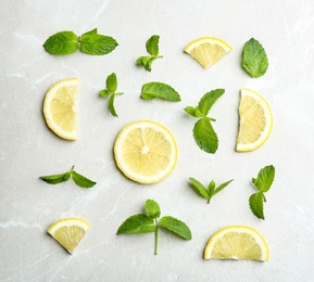 Fresh mint with sliced lemon on grey marble background, flat lay