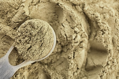 Photo of Hemp protein powder and measuring scoop, closeup