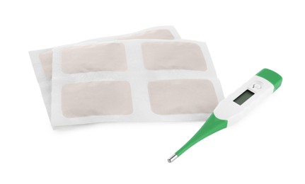 Photo of Mustard plasters and thermometer on white background