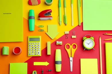 Photo of Different bright school stationery on color background, flat lay
