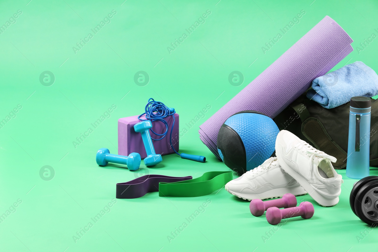 Photo of Many different sports equipment on green background, space for text