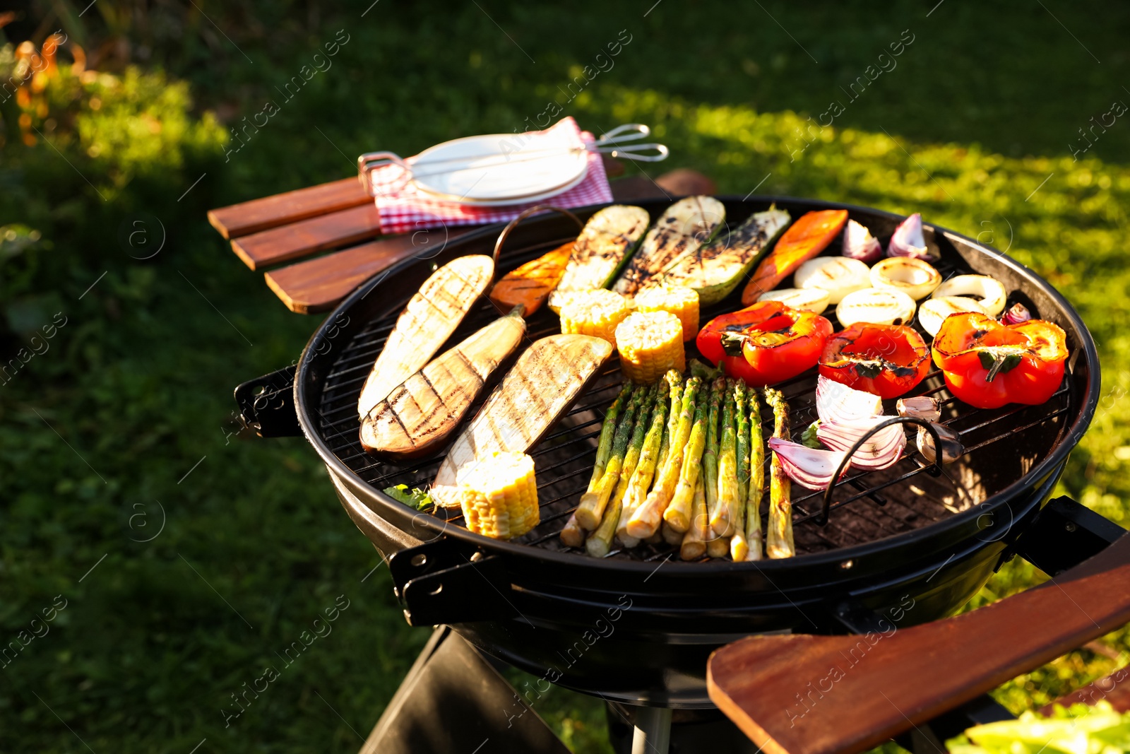 Photo of Delicious grilled vegetables on barbecue grill outdoors