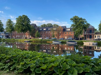 Photo of Beautiful view of street near river with moored boats