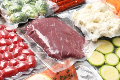 Photo of Many different food in vacuum packings as background, closeup