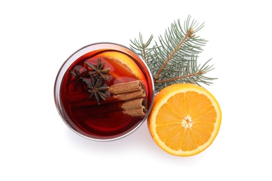 Photo of Glass of mulled wine with fir branch and orange isolated on white, top view