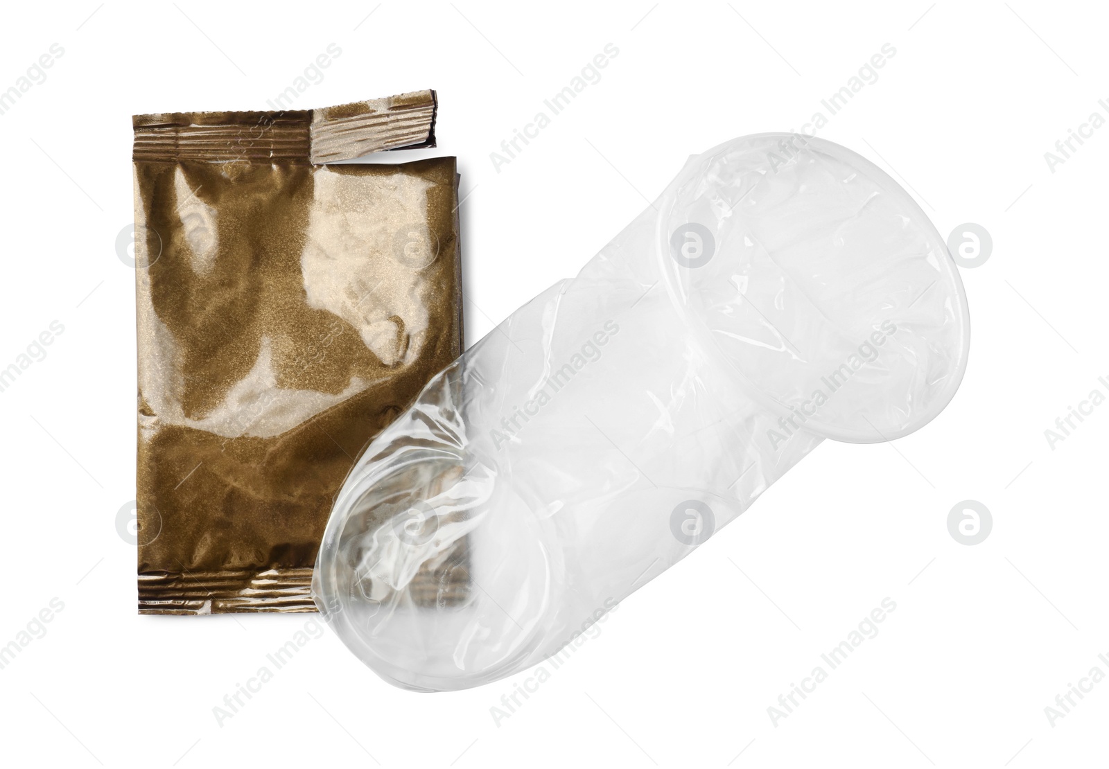 Photo of Unrolled female condom and torn package isolated on white, top view. Safe sex