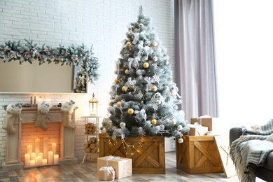 Stylish interior with decorated Christmas tree in living room