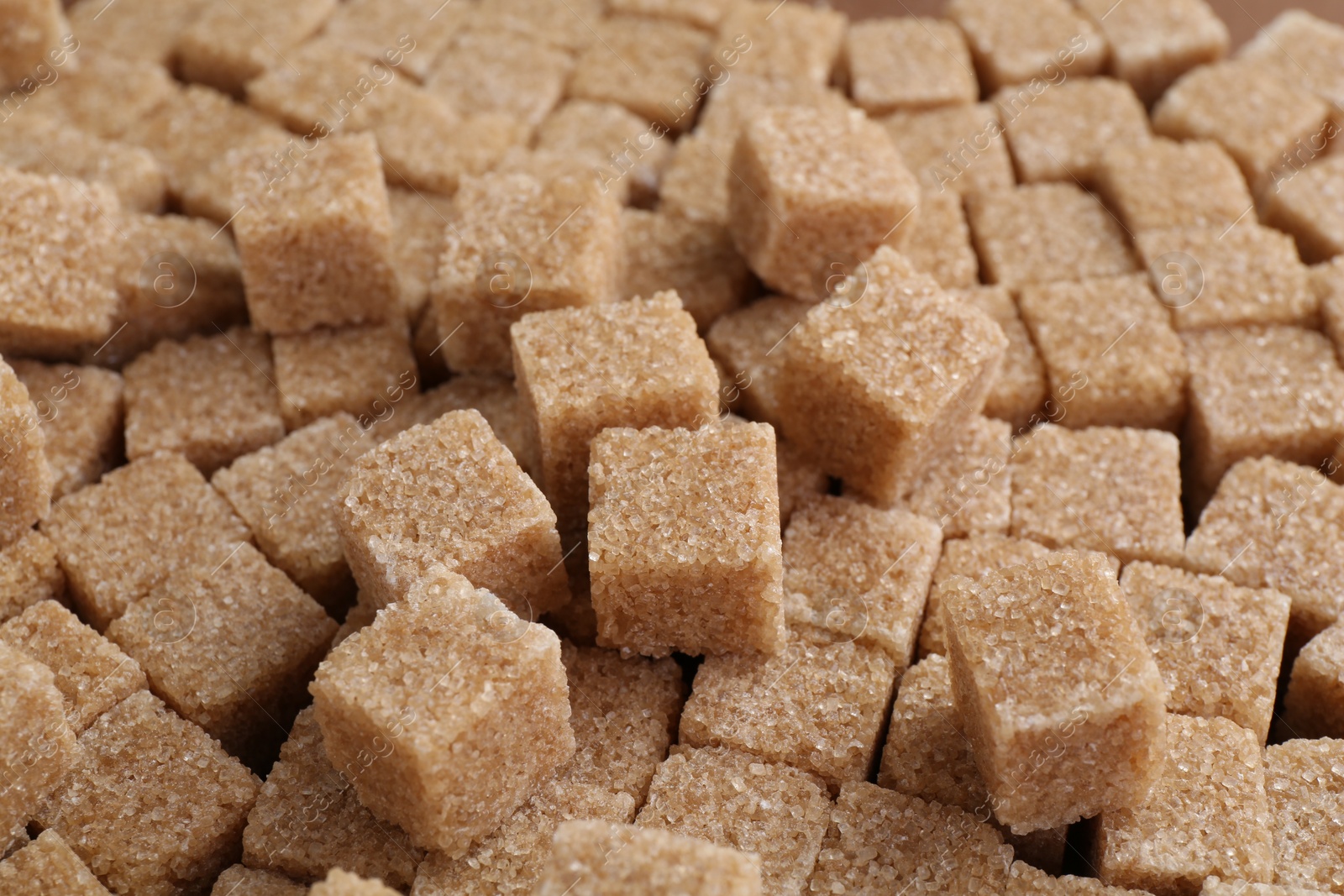 Photo of Brown sugar cubes as background, closeup view