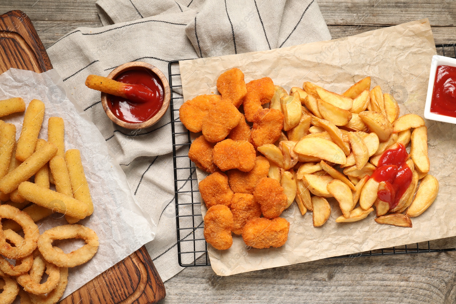 Photo of Different snacks and tasty ketchup on table, flat lay