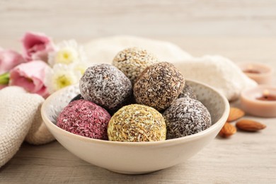 Different delicious vegan candy balls on white wooden table