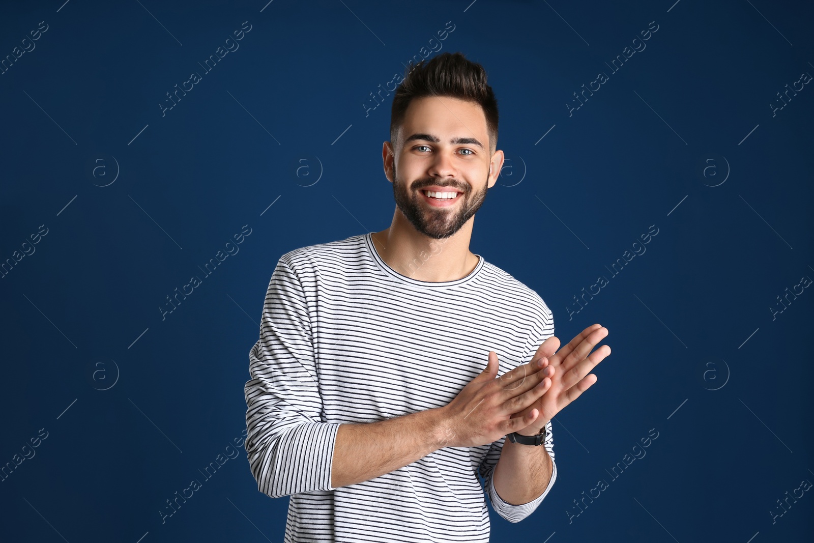 Photo of Portrait of handsome smiling man on color background