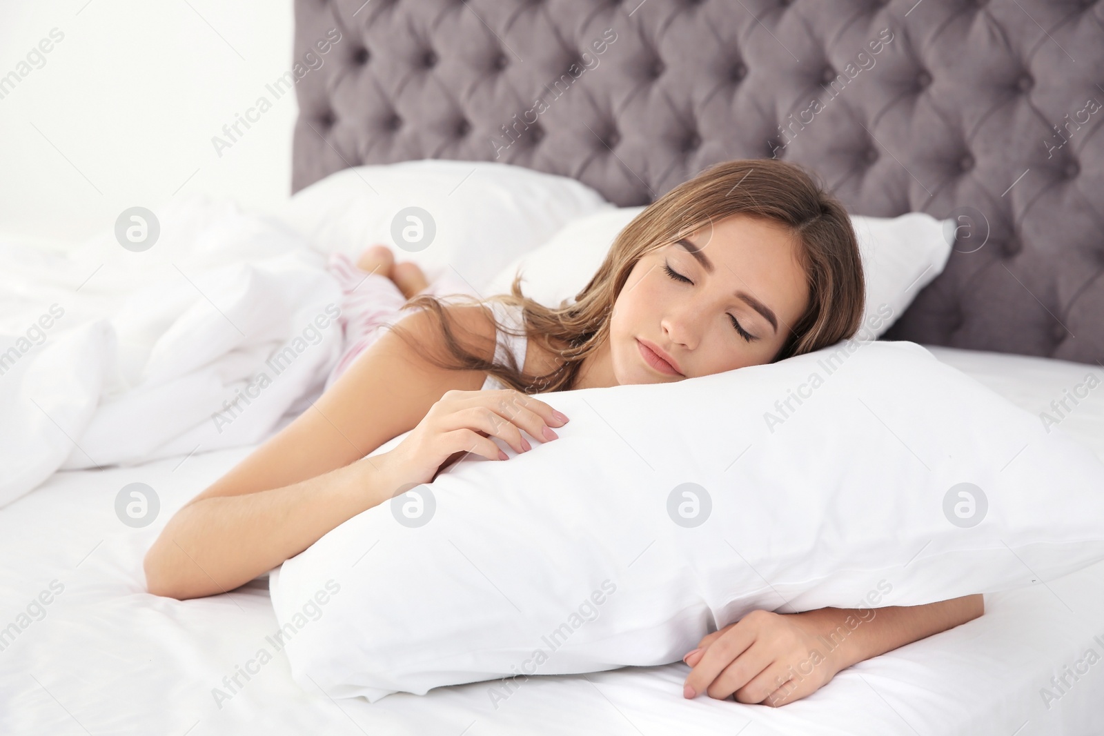 Photo of Beautiful teen girl sleeping with comfortable pillow in bed at home