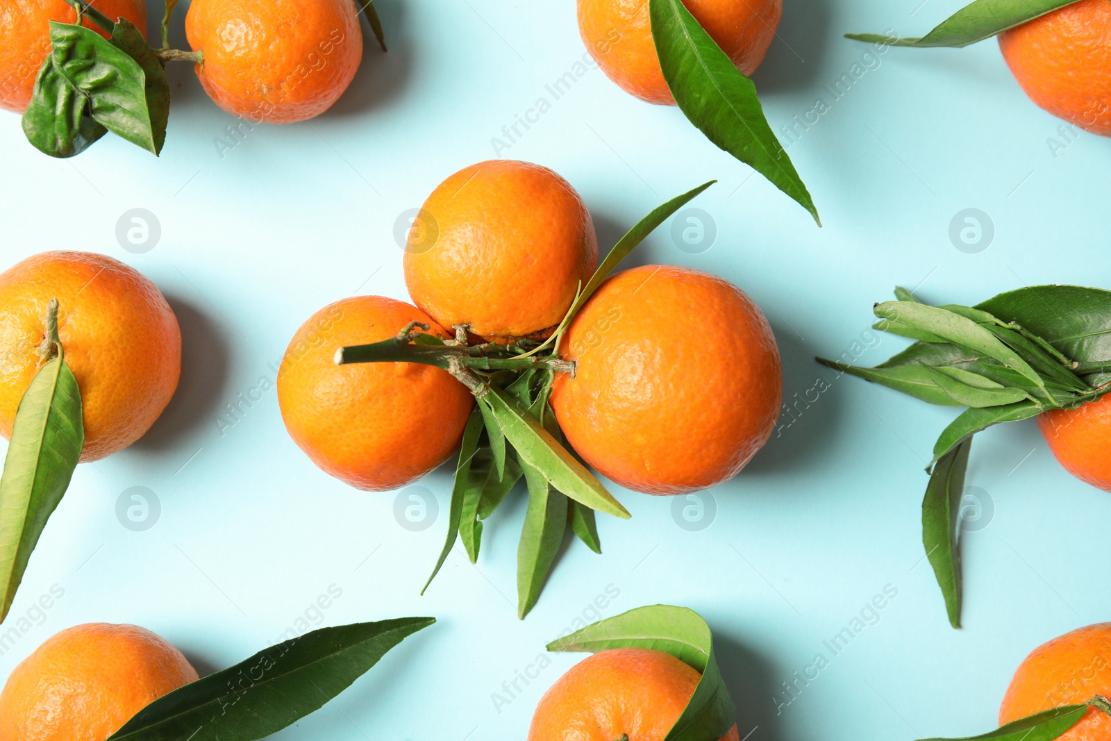 Photo of Flat lay composition with ripe tangerines on color background