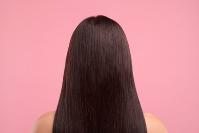 Photo of Woman with healthy hair on pink background, back view