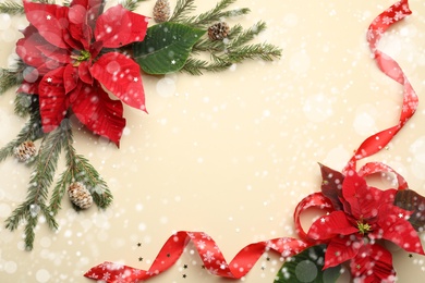 Image of Flat lay composition with traditional Christmas poinsettia flowers and space for text on beige background. Snowfall effect