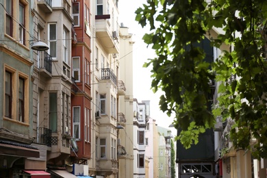 Photo of Narrow city street with beautiful apartment buildings