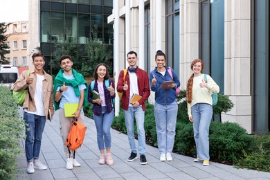 Photo of Group of happy students walking together outdoors