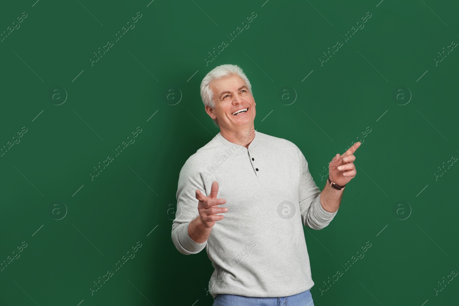 Photo of Portrait of handsome mature man on color background