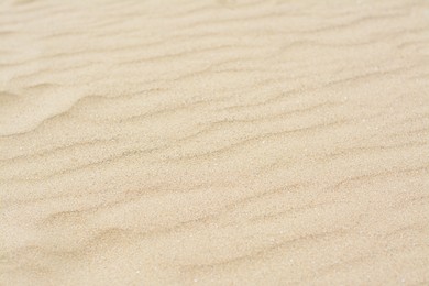 Dry beach sand with wave pattern as background