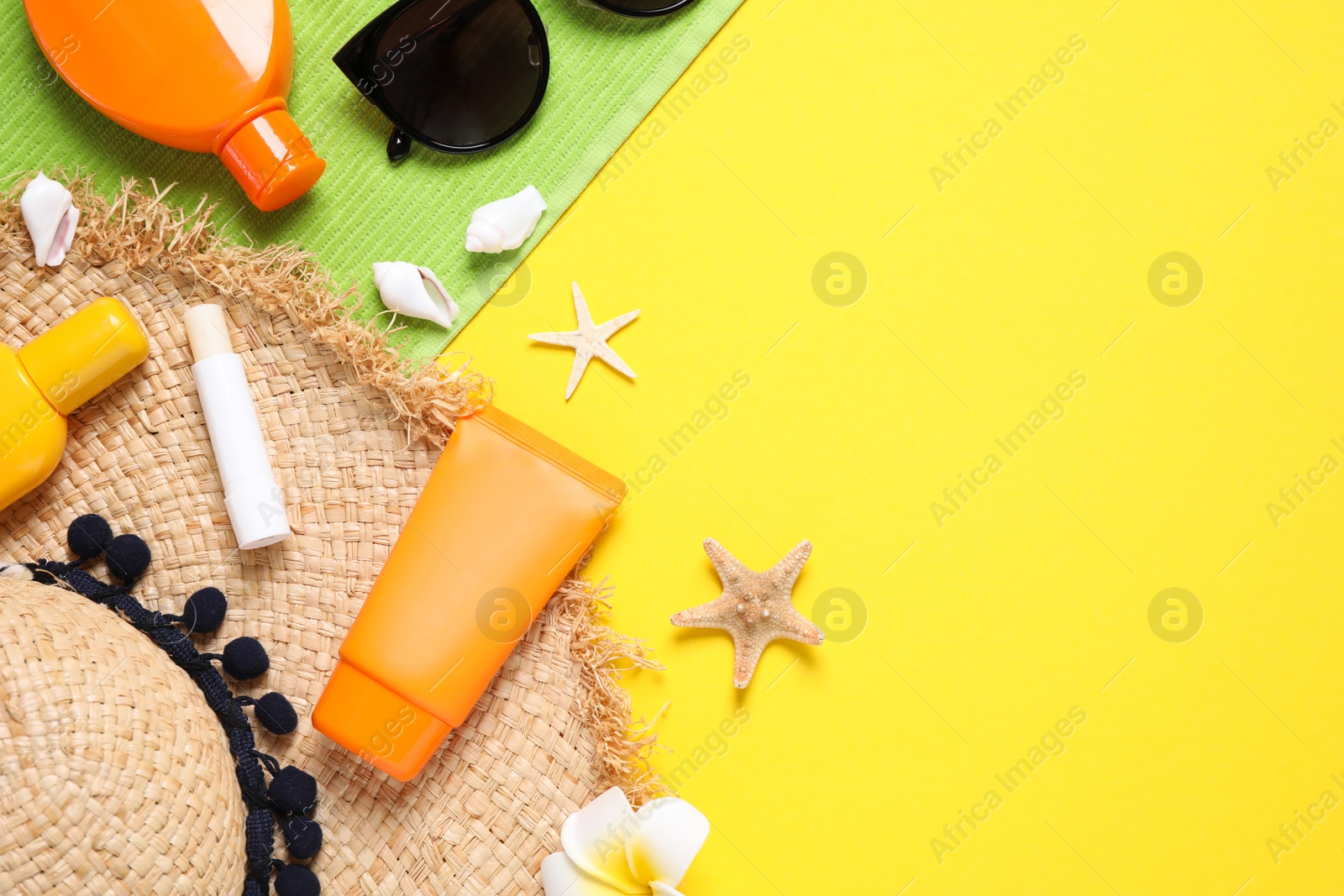 Photo of Flat lay composition with sun protection products on yellow background. Space for text