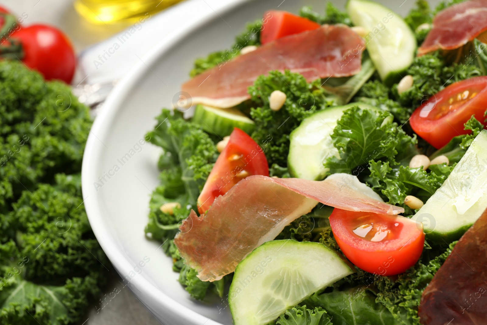 Photo of Delicious salad with kale leaves on table, closeup