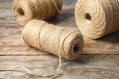 Photo of Natural hemp rope spools on wooden table