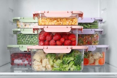 Boxes with different products inside of refrigerator