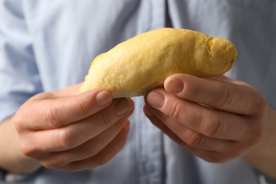 Photo of Woman with piece of fresh ripe durian, closeup