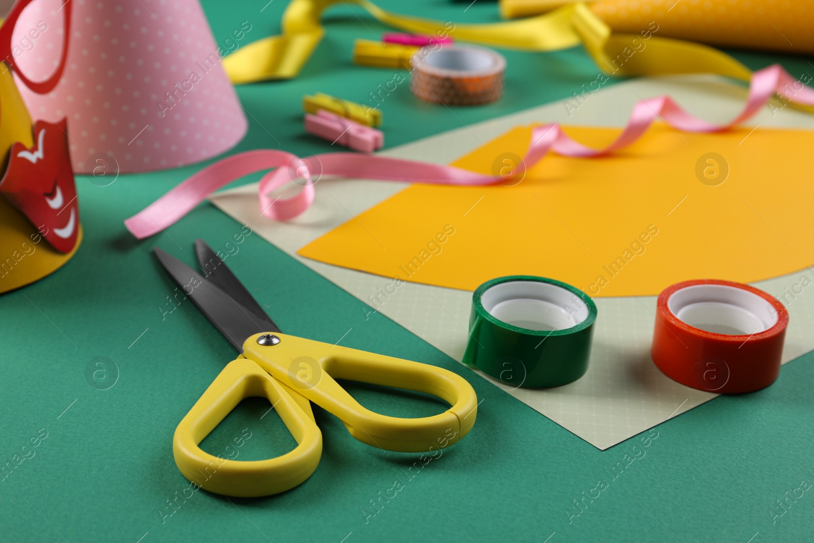 Photo of Handmade party hat. Template and tools on green background, closeup