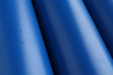 Photo of Energy drinks in blue cans as background, closeup