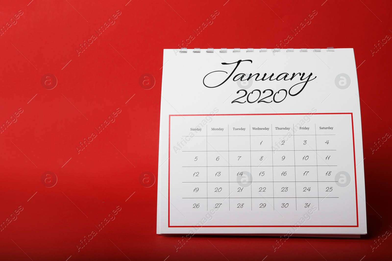 Photo of Paper calendar on red background. Planning concept