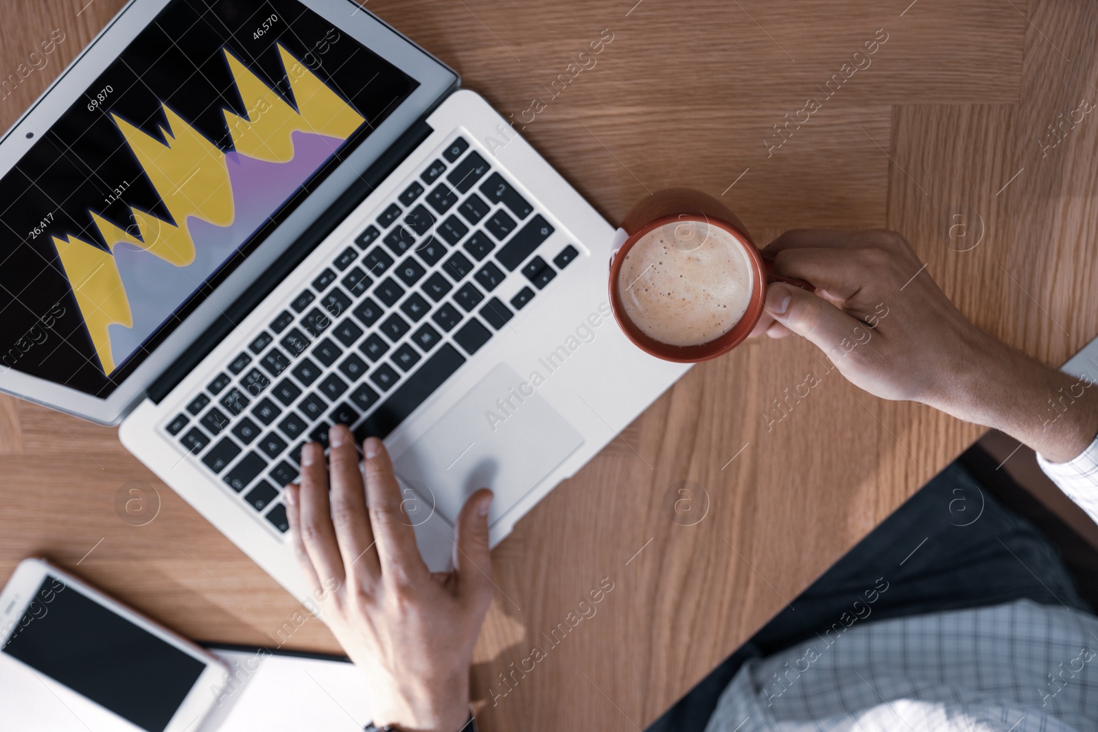 Image of  Broker working with laptop at table, closeup. Forex trading