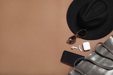 Photo of Flat lay composition with stylish hat on brown  background, space for text