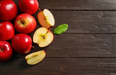 Fresh ripe red apples on wooden background