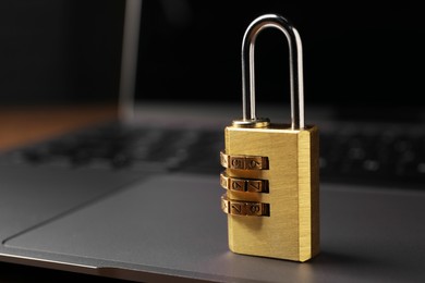 Photo of Cyber security. Padlock on laptop, closeup and space for text