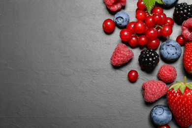 Photo of Different fresh berries on grey background, flat lay. Space for text