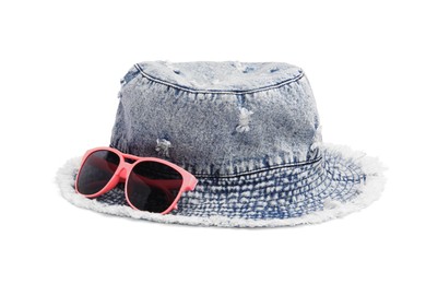 Photo of Denim hat and stylish sunglasses isolated on white. Beach objects