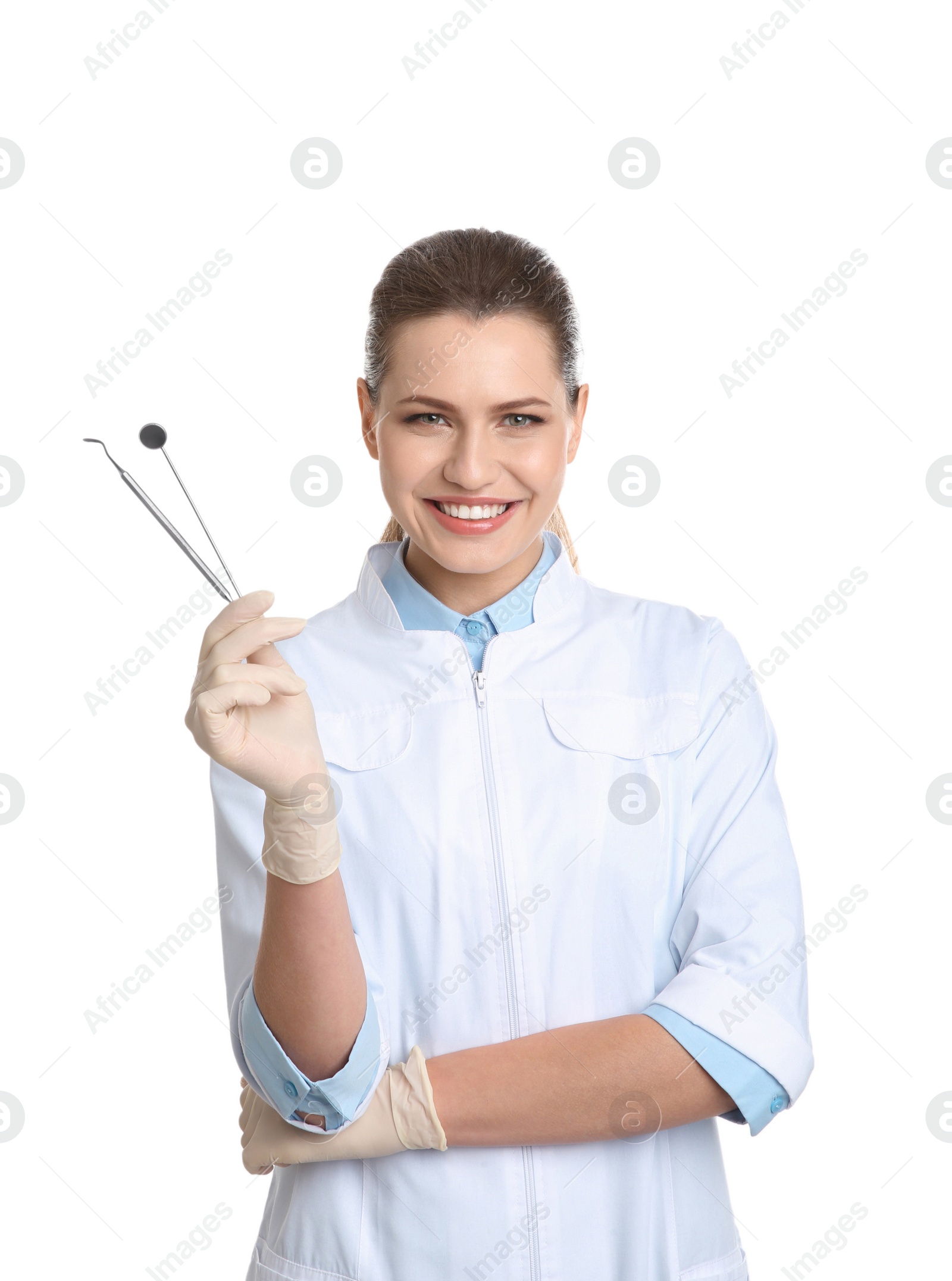 Photo of Female dentist holding professional tools on white background