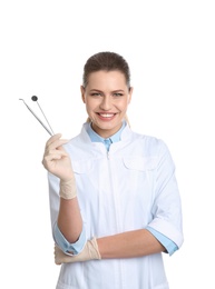 Female dentist holding professional tools on white background