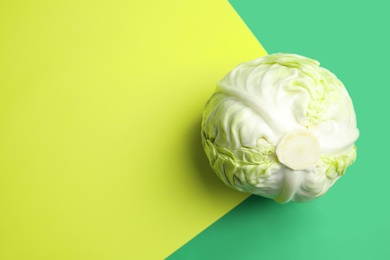 Photo of Ripe cabbage on color background, top view