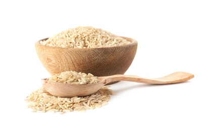 Photo of Bowl and spoon with uncooked brown rice on white background