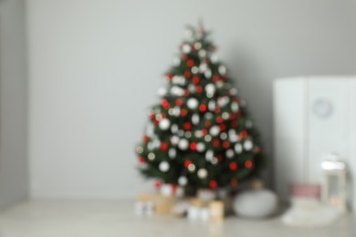 Photo of Blurred view of beautifully decorated Christmas tree in room